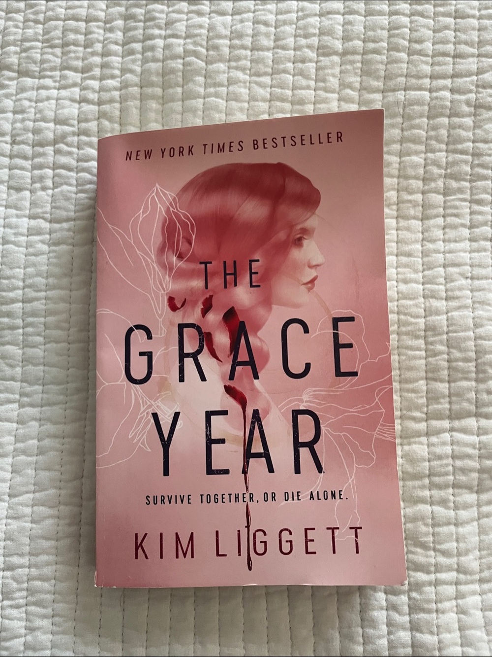 The Grace Year by — Pink Paperback Novel